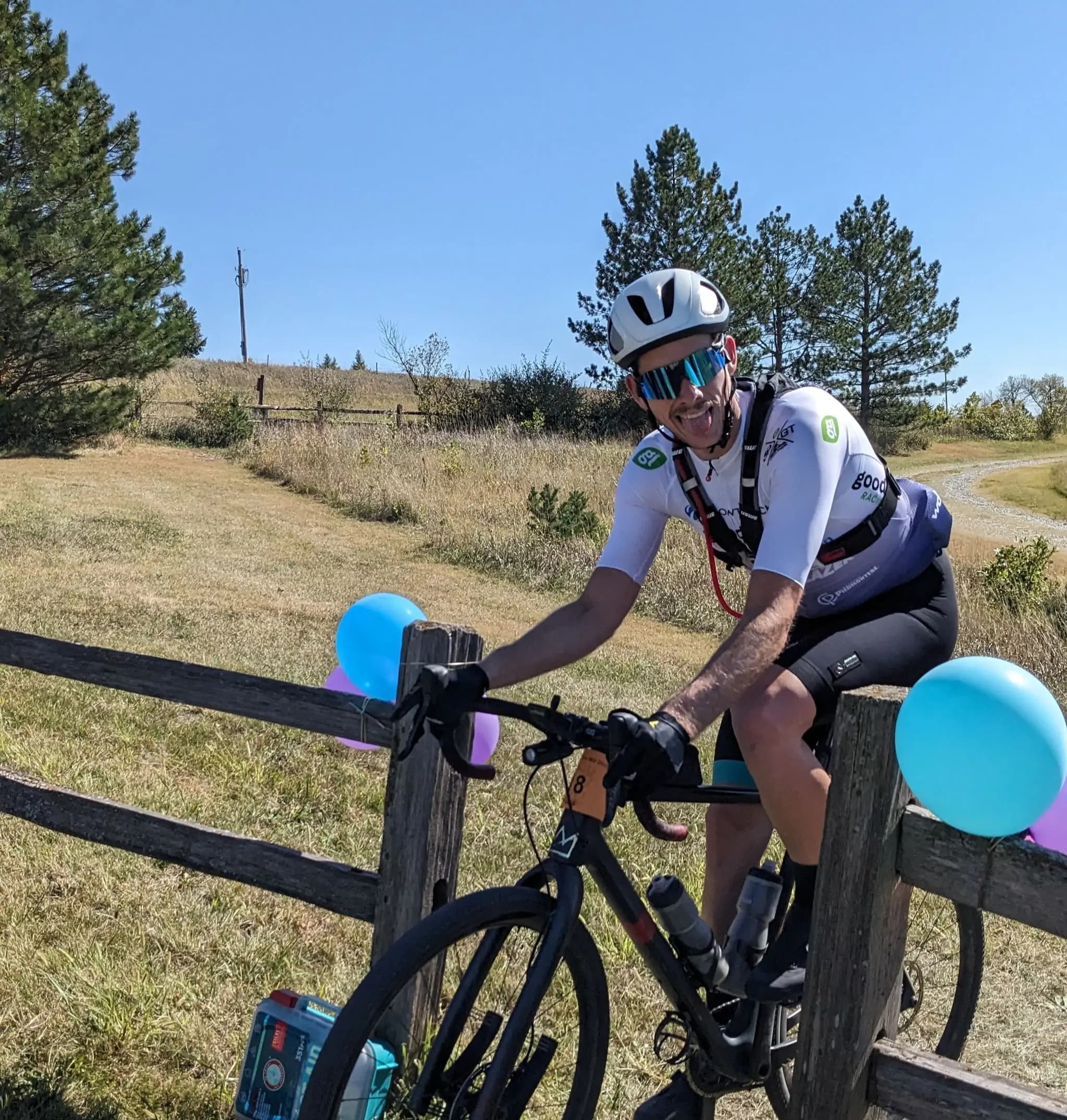 Organizer Trevor Slawnyk on a black gravel bike as he finishes a gravel race.